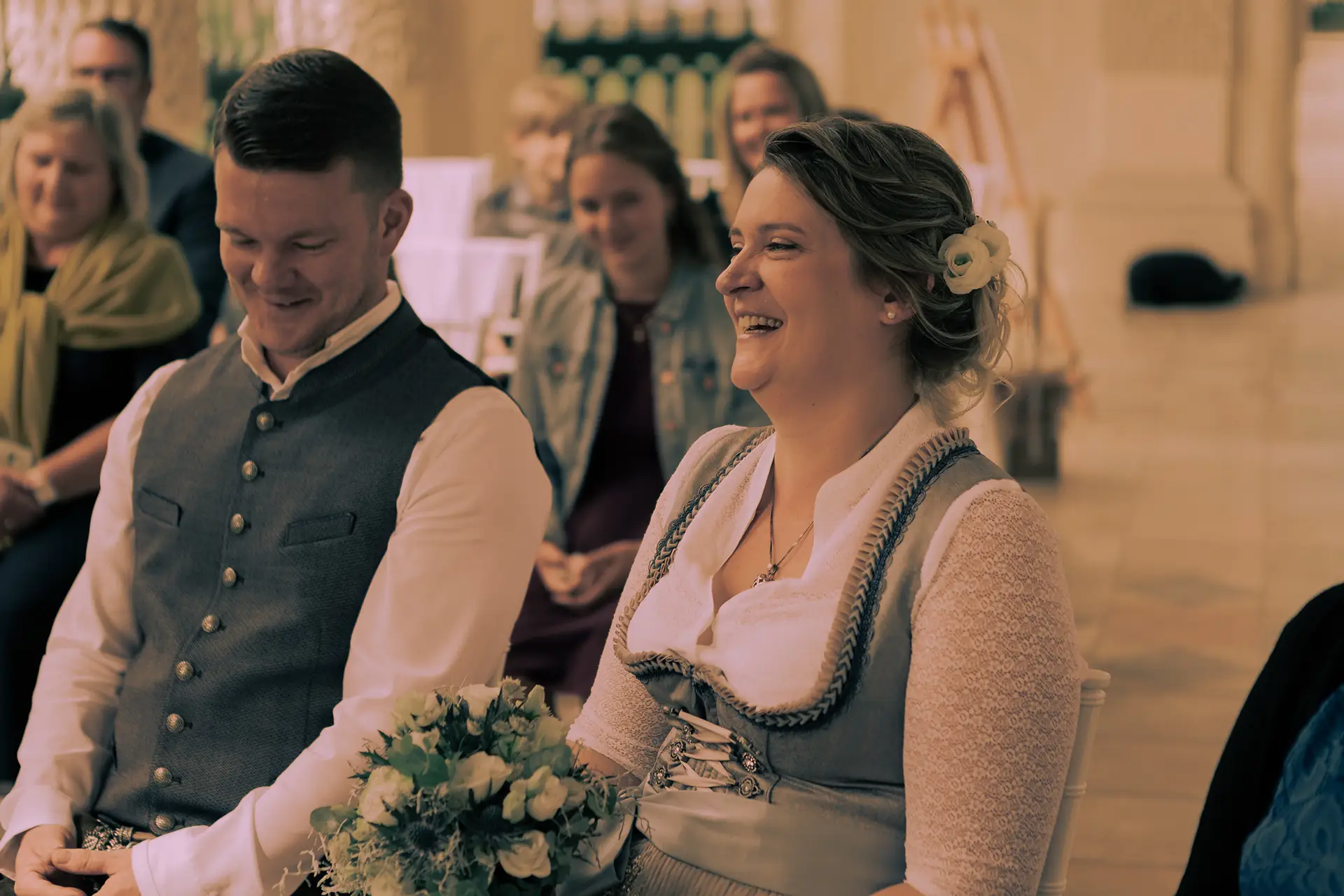 Das Brautpaar bei der standesamtlichen Hochzeit im Muschelpavillon in Eichstätt, die Braut lacht.